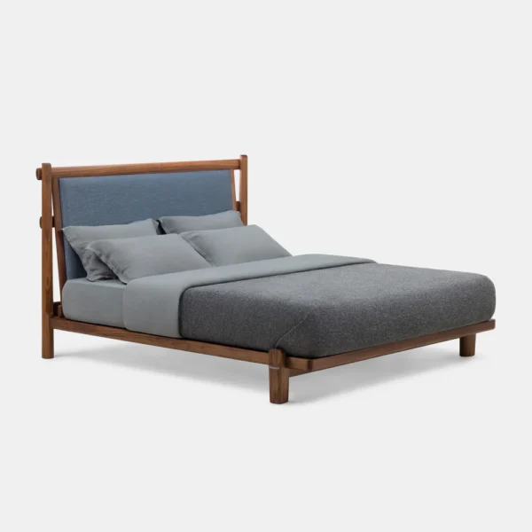 TWENTY-FIVE UPHOLSTERED BED